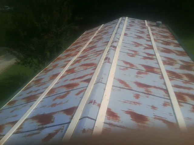 Rusted metal roof panels with new wood purlins before replacement — Storm Damage Roof Repair in Citrus Heights by Roofing Brothers