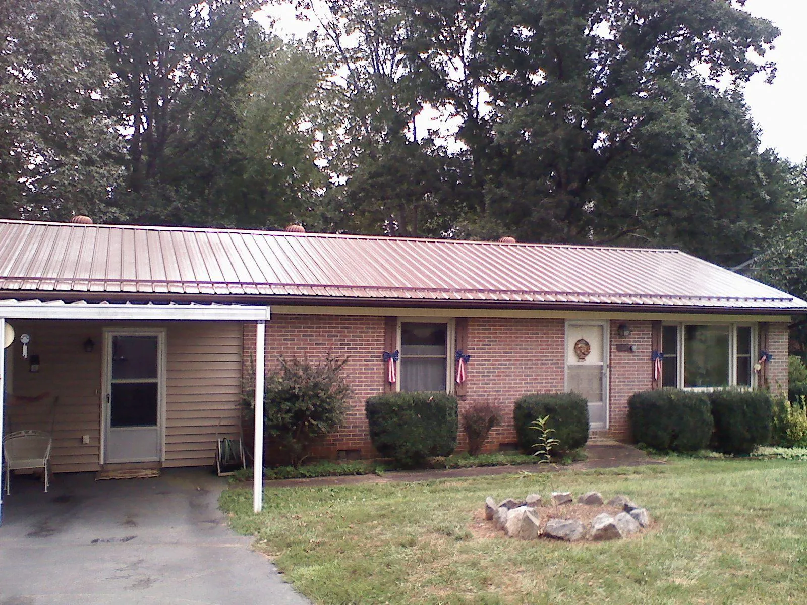 Bronze metal roof and carport on a brick ranch home — Roof Repair work by our crew in Citrus Heights