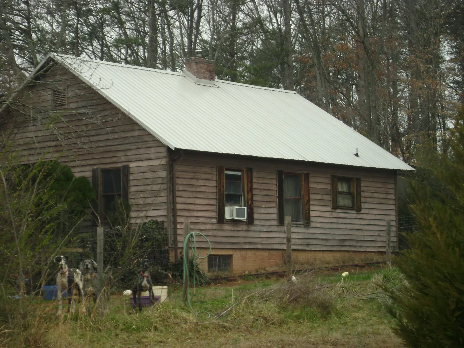 White metal roof on an old wood sided farmhouse, from a Metal Roof Installation job in Citrus Heights